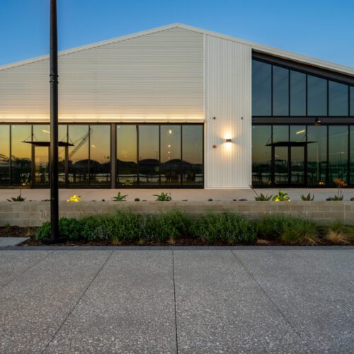 Architectural metal building featuring walls of glass.