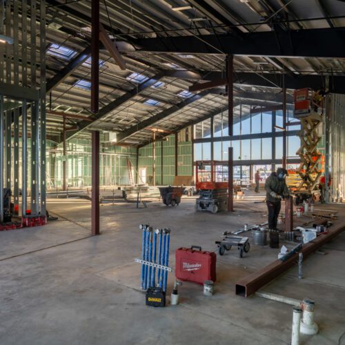 Construction of a large metal building interior.