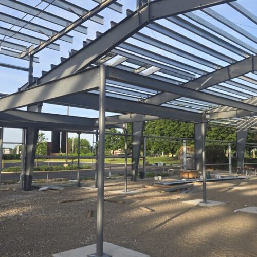 Construction progress featuring the main steel columns of the mezzanine of a metal building in Chicago