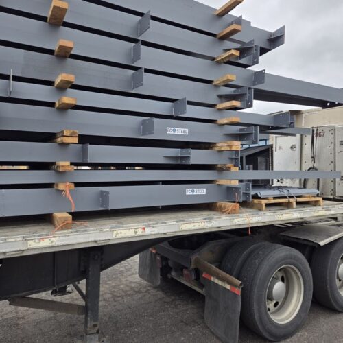 Match Haus construction site offloading EcoSteel beams.